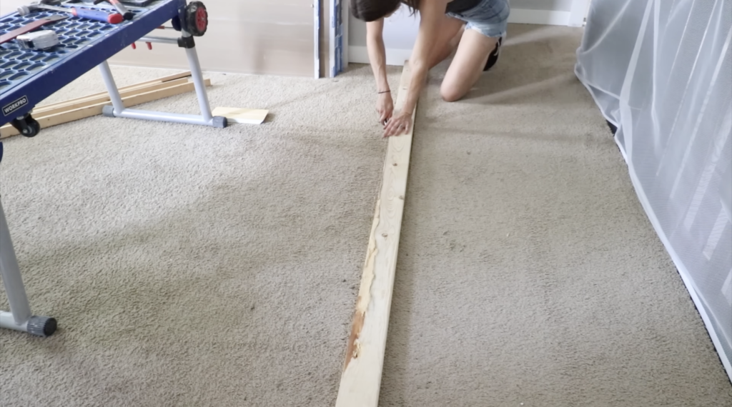 cutting around a 2x4 as a guide for the flooring 